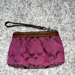 Coach burgundy and chocolate brown wristlet.